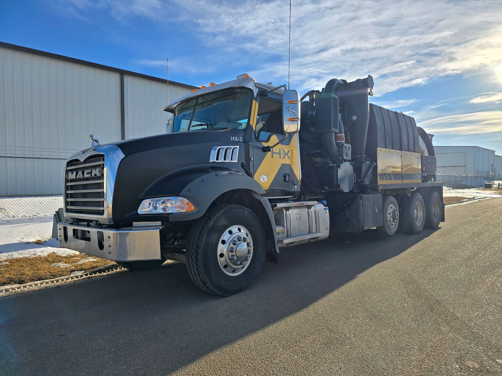 Black and yellow Mack HX-3 hydro excavation vacuum truck